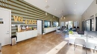 Located at 2000 Village Bluff Place in Raleigh, NC, this single-story amenity center serves as the welcoming hub of the Neuse Bluff community. The leasing office and lobby area greet visitors with soaring vaulted ceilings, large windows that invite abundant natural light, and polished tile flooring throughout. A bold, geometric accent wall in earthy tones anchors the reception desk and built-in cabinetry, while multiple mounted displays showcase available floor plans. A cozy café station offers refreshments alongside a comfortable seating arrangement with a tufted navy sofa and modern accent chairs, creating an inviting atmosphere for prospective and current residents alike.

The fitness center is a standout feature of the space, thoughtfully designed across multiple connected zones. Deep navy accent walls, rubberized flooring, and ceiling fans set an energetic tone throughout. The cardio area is lined with a row of treadmills and additional machines, while the strength training zones offer a comprehensive selection of free weights, dumbbells, kettlebells, cable machines, Smith machines, resistance equipment, and adjustable benches. Full-length mirrors maximize the sense of space and support workout visibility. Motivational artwork and recessed lighting complete the gym's dynamic, fitness-forward aesthetic.