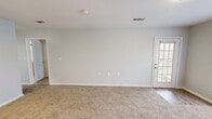 Located at 5001 Pecan Acres Street in Lake Charles, Louisiana, this single-story, one-bedroom, one-bathroom home offers a practical and well-organized layout. The living room features neutral-toned carpet, clean white walls, and a door providing access to the exterior, allowing natural light to filter in and creating a welcoming, open feel.

The galley-style kitchen is efficiently designed with warm oak cabinetry lining both walls, light countertops, wood-look vinyl flooring, and white appliances including a refrigerator, dishwasher, and electric range. A double-door pantry provides additional storage, and the layout flows conveniently toward a dedicated laundry area and electrical panel.

The bedroom is a comfortable, well-proportioned retreat with plush carpet, soft neutral walls, a ceiling fan with light fixture, and two windows that invite an abundance of natural light and outdoor views, enhancing the room's airy atmosphere. A closet provides organized storage for the bedroom.

The bathroom features wood-look vinyl flooring, a vanity with warm cabinetry, a toilet, and a full bathtub-shower combination with chrome fixtures. Clean white walls and bright finishes give the bathroom a tidy, functional character. Overall, this home delivers a straightforward, efficient living environment suited for comfortable everyday living.