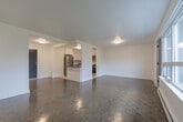 Located at 285 Erb St W in Waterloo, Ontario, this well-appointed 2-bedroom, 1-bathroom unit offers a thoughtfully designed layout across a single floor. The open-concept living and kitchen area forms the heart of the unit, with dark parquet flooring, large windows that invite natural light, and a baseboard heating system throughout. A partial divider with a dark countertop neatly separates the living space from the kitchen, which features white shaker-style cabinetry, a classic subway tile backsplash, light tile flooring, and a full suite of stainless steel appliances including a refrigerator, stove, microwave, and dishwasher. The two bedrooms are bright and well-sized, each with large windows offering treetop views, parquet flooring, and baseboard heaters. The primary bedroom includes mirrored sliding closet doors, while the second bedroom benefits from direct access to a private balcony. The bathroom is finished with a full soaker tub and clean white subway tile surround. Crisp white walls throughout lend the unit a fresh, neutral aesthetic, making it a versatile and move-in ready space in a natural Waterloo setting.