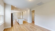 Located at 304 Bedstone Dr in Navassa, NC, this single-story, 3-bedroom, 2-bathroom home offers a clean, modern aesthetic throughout its thoughtfully designed floor plan. The open-concept living area seamlessly connects the living room, dining room, and kitchen, all finished with light hardwood-style flooring and neutral toned walls that create a bright, cohesive atmosphere. Recessed lighting and a decorative chandelier add warmth to the shared living space.

The kitchen is well-appointed with white shaker-style cabinetry, granite countertops, a center island with a sink, and stainless steel appliances including a range and over-the-range microwave. A window above the counter brings in natural light and neighborhood views.

The spacious primary bedroom features hardwood-style flooring, a window, and direct access to a walk-in closet with wire shelving. The primary bathroom offers a dual-sink vanity with white countertops, white cabinetry, and a large mirror. The additional bedrooms are well-sized with ample natural light and closet access.

A dedicated laundry room houses a full-size Whirlpool washer and dryer with overhead wire shelving. The attached garage provides generous vehicle and storage space with an automatic opener. The property also includes a fenced backyard, offering a private outdoor area.