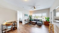 Located at 1133 27th Street in San Diego, CA, this efficiently designed 1-bedroom, 1-bathroom single-floor home offers a well-appointed and cohesive living experience. Warm hardwood flooring flows throughout, unifying each room with a consistent and inviting aesthetic.

The combined kitchen and living area forms the heart of the home. The living room benefits from a large window that fills the space with natural light and frames views of the surrounding neighborhood, complemented by a ceiling fan overhead. A charming arched pass-through connects the living area to the kitchen, which features sage-green shaker cabinetry, granite countertops, stainless steel appliances, and a breakfast bar — a functional and attractive space for cooking and casual dining.

The bedroom is a calm retreat, highlighted by expansive windows with neighborhood views, hardwood flooring, and a mirrored sliding-door closet that enhances the sense of space. The bathroom includes classic white tile walls, tile flooring, and a clawfoot-style bathtub with shower, adding a touch of vintage character.

Throughout the home, a coastal-inspired design theme ties the interiors together, creating a relaxed and comfortable atmosphere well-suited to the Southern California lifestyle.