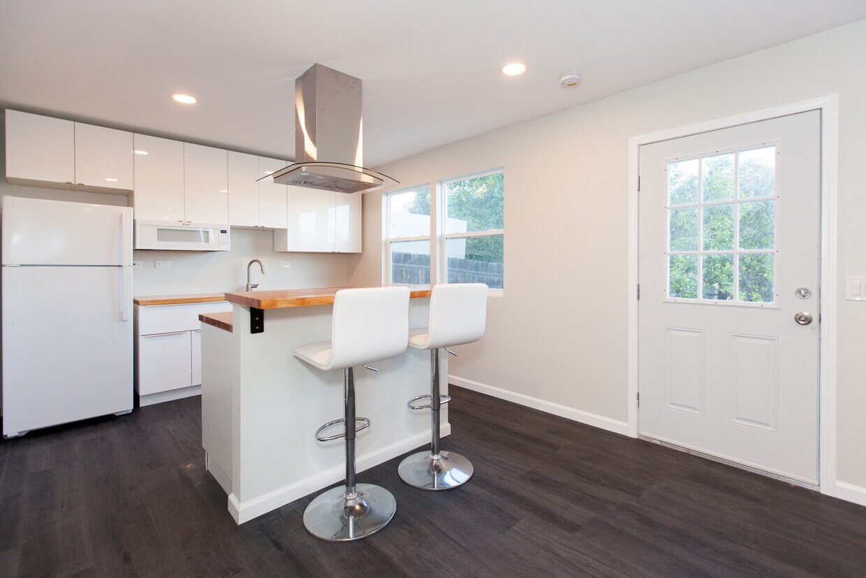 Kitchen view from living area. Barstools included. - 4358 Aragon Dr