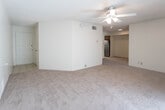 This single-floor unit offers a practical and comfortable layout across several well-defined living spaces. The living room serves as the central gathering area, featuring soft wall-to-wall carpeting, a ceiling fan with light fixture, a textured ceiling, and a full-width sliding glass door fitted with vertical blinds that opens to an outdoor patio, flooding the room with natural light and providing exterior views.

The kitchen is finished with light tile flooring, warm-toned oak cabinetry offering ample upper and lower storage, a double-basin stainless steel sink, a dishwasher, and a stove. A closet within the kitchen area provides additional storage convenience.

The bedrooms are carpeted and each equipped with a ceiling fan. The primary bedroom includes a spacious walk-in closet with built-in shelving and hanging rods, while additional bedrooms offer generous proportions and natural light through windowed walls. Each room maintains a clean, neutral palette throughout.

Two full bathrooms serve the unit, each featuring a shower-tub combination, toilet, tile flooring, and a vanity with oak cabinetry and an integrated sink. The overall ambiance is understated and functional, with consistent neutral tones creating a cohesive feel throughout the space.