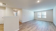 Located at 1000 Self Court in Middletown, NJ, this two-bedroom, one-bathroom residence offers a clean, modern aesthetic throughout its single-floor layout. Warm wood-look flooring runs continuously across all living areas, creating a cohesive and inviting atmosphere. The open-concept living room and kitchen area forms the heart of the home, bathed in natural light from large windows with views to the outdoors. Recessed lighting provides ample illumination throughout. The kitchen is well-appointed with gray shaker-style cabinetry, white countertops, a stainless steel sink, and stainless steel appliances including a range and dishwasher, complemented by a functional pass-through that connects to the living space. Both bedrooms are generously sized with neutral wall tones, wood-look flooring, and windows that bring in natural light. The primary bedroom features a dedicated closet with built-in shelving, offering practical storage. The full bathroom is thoughtfully designed with accessibility in mind, featuring grab bars, a combination tub and shower, a gray vanity with white countertop, large-format tile flooring, and a mirror. Two closets provide additional storage throughout the home. The overall ambiance is bright, clean, and move-in ready.