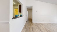 Located at 3733 N Goldenrod Rd in Winter Park, FL, this two-bedroom, one-bathroom single-story home offers a clean, functional layout with a bright and neutral aesthetic throughout. Light wood-look flooring runs continuously across every room, creating a cohesive and easy-to-maintain interior.

The living room serves as the heart of the home, featuring a classic fireplace with a white mantel, a large window that fills the space with natural light, and a glass-panel door providing additional brightness. The kitchen connects to the living area via a pass-through window with light countertops, white cabinetry, and stainless steel appliances including a refrigerator and range. A hallway leads to the laundry area and additional storage.

Both bedrooms are comfortably sized, each equipped with ceiling fans and windows that bring in natural light and outdoor views. The primary bedroom includes a walk-in closet with built-in shelving, offering practical storage solutions. The second bedroom is similarly bright and versatile.

The bathroom features a full tub-shower combination with clean white tile surround and chrome fixtures. Throughout the home, textured ceilings, crisp white trim, and a warm neutral color palette contribute to a tidy and welcoming ambiance well-suited for comfortable everyday living.