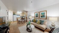 Located at 5601 Natomas Blvd in Sacramento, CA, this efficiently designed one-bedroom, one-bathroom residence makes excellent use of its single-floor layout. The open-concept living and dining area serves as the heart of the home, featuring light-toned flooring, a ceiling fan, and large windows fitted with blinds that allow natural light to fill the space. The living area offers a comfortable and welcoming ambiance, flowing seamlessly into a dedicated dining space. The kitchen is equipped with light wood cabinetry, laminate countertops, white appliances including a range, built-in microwave, dishwasher, and refrigerator, all set over durable hardwood-style flooring. The spacious bedroom includes a ceiling fan, a generous closet, and a window with blinds and warm drapery that lends a cozy atmosphere. The full bathroom features a tub-shower combination, a vanity with storage, and hardwood-style flooring. Additional practical amenities include a dedicated laundry area and hallway with closet storage. The overall design is clean and bright, with white walls and neutral finishes throughout that create a calm, functional living environment.