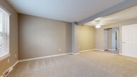 Located at 2287 Pinnacle Ct in Erie, PA, this 2-bedroom, 2-bathroom home spans three floors, offering a well-organized layout with dedicated spaces for living, dining, and utility needs. The ground floor houses an attached garage with a full automatic door and a utility room. The main living level features two distinct living areas, both finished with neutral-toned carpet and warm beige walls. A ceiling fan with integrated lighting adds comfort to the open living space. The kitchen is well-appointed with rich, dark wood cabinetry, white countertops, stainless steel appliances including a range, microwave, and dishwasher, and light hardwood-style flooring. A bright window on this floor fills the entry area with natural light. The upper floor is home to two carpeted bedrooms, including a spacious primary bedroom featuring a large closet with bi-fold doors and access to an adjacent room. Both bathrooms are clean and functional, one featuring a white vanity with a framed mirror and brushed nickel fixtures. Throughout, the home maintains a consistent neutral color palette of warm beige and gray tones, creating a cohesive and move-in ready atmosphere.