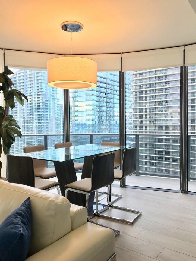 Dining room with city skyline views. - 55 SW 9th St