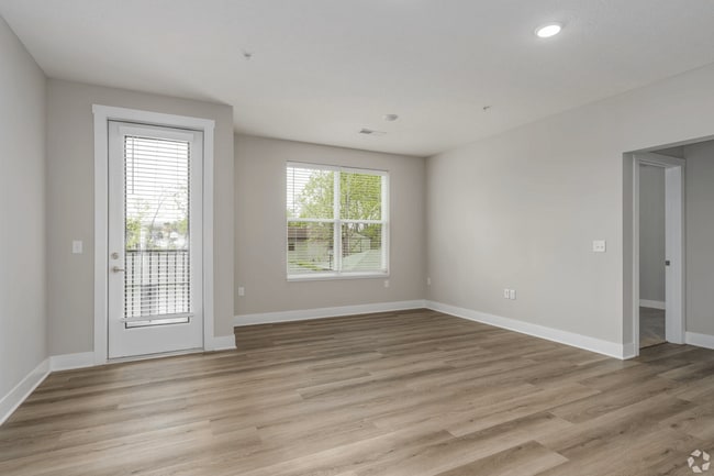 Living area with a patio/balcony of an apartment home at Tiffany Flats. - Tiffany Flats