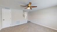 Located at 511 Avondale Rd in Dundalk, Maryland, this two-story home offers a well-organized layout across two floors, providing comfortable living space for everyday life. The main floor features two living areas with plush wall-to-wall carpeting, ceiling fans with integrated lighting, and neutral-toned walls that create a bright and welcoming atmosphere. A staircase with classic white balusters connects the two levels, adding a traditional architectural touch. The kitchen is thoughtfully updated with crisp white shaker-style cabinetry, light marble-look countertops, a stainless steel undermount sink, and a full suite of stainless steel appliances including a gas range and refrigerator. Light wood-look flooring runs through the kitchen and adjoining areas, lending a clean, modern feel. The bathrooms are finished in a fresh, all-white palette featuring a tub-shower combination, light wood-look flooring, and a window for natural ventilation. Upstairs, the four bedrooms are carpeted and include ceiling fans, generous closet space, and windows dressed with white blinds that invite natural light. With eight closets distributed throughout the home, storage is plentiful. The overall aesthetic is clean, neutral, and move-in ready.