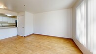 Located at 200 Valencia Dr SE in Albuquerque, New Mexico, this two-bedroom, two-bathroom residence offers a thoughtfully arranged single-floor layout with clean, bright interiors throughout. Light wood-style flooring runs consistently across the living spaces, complementing the crisp white walls and creating a cohesive, airy atmosphere.

The kitchen is a functional highlight, featuring white cabinetry, granite-style countertops, a black range with overhead ventilation, and a skylight that fills the space with natural light. The kitchen flows conveniently into a combined dining and living area — a generous, open space with room for both relaxing and entertaining.

A hallway connects the main living areas to the two bedrooms, each of which benefits from natural light via large windows fitted with vertical blinds. The primary bedroom is a comfortable, well-proportioned retreat with its own en-suite bathroom featuring white cabinetry and granite-style countertops, as well as access to a spacious walk-in closet with built-in shelving. The second bathroom is clean and compact with a wall-mounted sink and mirrored medicine cabinet.

Additional conveniences include dedicated in-unit laundry, a balcony for outdoor access, and a total of three closets for ample storage throughout the home.