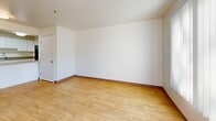 Located at 200 Valencia Dr SE in Albuquerque, New Mexico, this two-bedroom, two-bathroom residence offers a thoughtfully arranged single-floor layout with clean, bright interiors throughout. Light wood-style flooring runs consistently across the living spaces, complementing the crisp white walls and creating a cohesive, airy atmosphere.

The kitchen is a functional highlight, featuring white cabinetry, granite-style countertops, a black range with overhead ventilation, and a skylight that fills the space with natural light. The kitchen flows conveniently into a combined dining and living area — a generous, open space with room for both relaxing and entertaining.

A hallway connects the main living areas to the two bedrooms, each of which benefits from natural light via large windows fitted with vertical blinds. The primary bedroom is a comfortable, well-proportioned retreat with its own en-suite bathroom featuring white cabinetry and granite-style countertops, as well as access to a spacious walk-in closet with built-in shelving. The second bathroom is clean and compact with a wall-mounted sink and mirrored medicine cabinet.

Additional conveniences include dedicated in-unit laundry, a balcony for outdoor access, and a total of three closets for ample storage throughout the home.