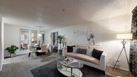 This single-floor residence offers a thoughtfully designed layout that balances comfort and functionality across its key living spaces. The open-concept living and dining area serves as the heart of the home, featuring durable wood-look flooring, a textured ceiling, and a large window with vertical blinds that allow natural light to fill the room. The living area provides a welcoming atmosphere, while the adjacent dining space is defined by a pendant light overhead and full-length wall mirrors that lend a sense of depth and openness to the area. The galley-style kitchen is efficiently laid out with warm wood cabinetry lining both sides, ample counter space, a double basin sink, and standard appliances including a refrigerator and range. Light-toned flooring completes the clean, practical aesthetic. The bedroom is a quiet retreat with plush carpet, a window with vertical blinds for natural light and privacy, and a sliding-door closet offering generous storage. The bathroom features warm wood cabinetry with a wide vanity, a large mirror with overhead lighting, and a full-size tub-shower combination. Throughout the residence, the neutral color palette and consistent finishes create a cohesive and inviting living environment.
