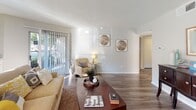 Located at 18880 Marsh Ln in Dallas, TX, this single-story residence offers a thoughtfully designed layout that balances comfort and functionality. The living room is bright and welcoming, featuring wood-style flooring, a textured ceiling, and a sliding glass door with vertical blinds that opens to an outdoor patio, allowing natural light to fill the space. A mirrored wet bar accent adds a distinctive touch to the living area.

The dining area is positioned near a bay of large windows, flooding the space with daylight and creating an airy, open atmosphere. Wood-style flooring continues throughout, complemented by a breakfast bar with seating that connects to the kitchen.

The kitchen is well-equipped with white cabinetry, granite-style countertops, stainless steel appliances including a refrigerator and dishwasher, and a tall window that brings in additional natural light.

Both bedrooms are carpeted and generously sized, each featuring ceiling fans, walk-in closets, and windows with outdoor views. The neutral color palette throughout lends a calm, cohesive feel to each room.

The bathroom is finished with white cabinetry, granite-style countertops, a large vanity mirror, and a tub-shower combination, providing a clean and functional space. Overall, this residence offers a comfortable and practical living environment in a prime Dallas location.