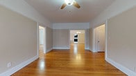 Located at 160 Maple St in Springfield, MA, this single-floor residence offers a thoughtfully arranged layout with a seamless flow between living areas. Warm-toned hardwood flooring runs throughout most of the space, lending a cohesive and inviting character to every room.

The living and dining areas are generously proportioned, with ceiling fans providing comfort and an elegant chandelier adding a refined touch to the dining space. Decorative wall paneling in the dining room enhances its classic architectural character, while open doorways connect the rooms naturally.

The kitchen stands out as a modern, well-equipped space featuring dark espresso cabinetry, stainless steel appliances including a refrigerator, range, and dishwasher, and crisp white countertops. A stylish mosaic tile backsplash adds visual interest, while large-format white tile flooring and recessed lighting complete the contemporary aesthetic. A charming French door connects the kitchen to adjacent areas.

The bedrooms are bright and airy, benefiting from multiple windows that invite natural light. One bedroom features a drop ceiling and views of the surrounding neighborhood. Closet space is well-integrated throughout.

The bathroom is cleanly appointed with white subway tile, a soaking tub, marble-look tile flooring, and a dark wood vanity, offering a calm and functional retreat.