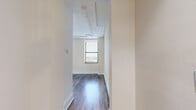 Located at 1001 E Main St in Richmond, VA, this two-story residence offers three bedrooms, three bathrooms, and a well-considered layout spread across two generously sized floors. Rich hardwood flooring runs throughout, lending warmth and continuity to every room.

The main level features an open-concept dining room, kitchen, and living room. The living area is highlighted by an ornate fireplace with a classic white mantle, decorative crown molding, and large windows that bring in natural light and city views. The kitchen is outfitted with gray shaker cabinetry, quartz countertops, stainless steel appliances, and brass hardware, accompanied by a convenient pantry and in-unit stacked washer and dryer.

Upstairs, the three bedrooms offer comfortable proportions, with the spacious primary bedroom providing ample room for furnishings. Three well-appointed closets, including walk-in storage with wire shelving, serve the bedrooms. The three bathrooms are clean and functional, featuring gray vanities with white countertops and tub/shower combinations.

A loft adds versatile bonus space, while two staircases and multiple hallways ensure smooth circulation between floors. Exposed ceiling details and multiple large windows facing the Richmond skyline complete the character of this distinctive urban residence.