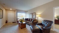 Located at 5423 Waterford Cir in Sheffield, Ohio, this single-floor residence offers a thoughtfully designed layout with a warm, cohesive aesthetic throughout. The living room serves as a welcoming centerpiece, featuring plush carpeting, neutral walls, and multiple windows that allow natural light to fill the space. The room comfortably accommodates generous seating arrangements, creating an inviting atmosphere for relaxation.

Adjacent to the living area is a dedicated dining nook, providing an intimate setting for meals. The kitchen is well-equipped with rich cherry wood cabinetry, granite countertops, tile flooring, and recessed lighting. A central island with bar seating adds both functionality and additional prep space, while white appliances, including a dishwasher and refrigerator, complete the layout. A hallway from the kitchen provides convenient access to additional rooms.

The primary bedroom is generously sized with soft carpeting and direct access to a walk-in closet and an en-suite bathroom featuring a vanity with cherry cabinetry and a glass-enclosed shower. A secondary bedroom offers a bright, versatile space with a large window and ample room. The second full bathroom includes a tub-shower combination and matching cherry vanity cabinetry, maintaining a consistent design language found throughout the home.