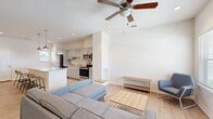 This two-story residence in Pullman, Washington offers a well-organized layout across two floors, with the main level dedicated to shared living spaces and the upper floor housing the majority of the bedrooms and bathrooms. The main floor opens into a bright, open-concept living and kitchen area finished with light hardwood-style flooring. The living room benefits from multiple windows that invite natural light and a ceiling fan overhead. The kitchen is equipped with stainless steel appliances, including a refrigerator, range, microwave, and dishwasher, complemented by gray cabinetry, granite countertops, and a peninsula that provides additional prep and seating space.

Each of the three bathrooms features a granite-topped vanity with gray cabinetry and a large mirror, maintaining a consistent, clean aesthetic throughout. The bathrooms include walk-in showers with white tile surrounds and brushed hardware.

The three bedrooms are carpeted and designed with simplicity in mind, featuring neutral walls and windows that allow for natural light and outdoor views. The primary bedroom offers a comfortable footprint with dual windows overlooking the surrounding neighborhood. Additional bedrooms are modestly sized, well-suited for functional use. Closets and a hallway provide practical storage and connectivity between spaces.