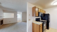 Located at 3070 Mill Pound Drive in Bellbrook, Ohio, this single-floor home offers a well-organized layout with a comfortable, functional design throughout. The galley-style kitchen is efficiently arranged with warm wood cabinetry on both sides, light countertops, tile flooring, and black appliances including a range, microwave, refrigerator, and dishwasher — providing ample storage and workspace. The kitchen opens toward the living area, which is a generously sized carpeted room anchored by a tile-surround fireplace and sliding glass doors that lead to a private outdoor deck, allowing for natural light and outdoor access. The bedrooms are carpeted and well-lit by windows fitted with blinds, offering a quiet and comfortable atmosphere. One bedroom features a walk-in closet and a ceiling fan, adding to its functionality. The bathrooms include wood-toned vanity cabinetry, tile flooring, and clean, straightforward fixtures. Textured ceilings are consistent throughout the home, complementing the neutral color palette of soft whites and warm beiges that give the space a bright, cohesive feel. This single-level home provides a practical and inviting living environment in the Bellbrook community.