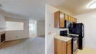Located at 3070 Mill Pound Drive in Bellbrook, Ohio, this single-floor home offers a well-organized layout with a comfortable, functional design throughout. The galley-style kitchen is efficiently arranged with warm wood cabinetry on both sides, light countertops, tile flooring, and black appliances including a range, microwave, refrigerator, and dishwasher — providing ample storage and workspace. The kitchen opens toward the living area, which is a generously sized carpeted room anchored by a tile-surround fireplace and sliding glass doors that lead to a private outdoor deck, allowing for natural light and outdoor access. The bedrooms are carpeted and well-lit by windows fitted with blinds, offering a quiet and comfortable atmosphere. One bedroom features a walk-in closet and a ceiling fan, adding to its functionality. The bathrooms include wood-toned vanity cabinetry, tile flooring, and clean, straightforward fixtures. Textured ceilings are consistent throughout the home, complementing the neutral color palette of soft whites and warm beiges that give the space a bright, cohesive feel. This single-level home provides a practical and inviting living environment in the Bellbrook community.