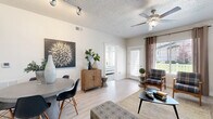 Located at 751 W 200 S in American Fork, Utah, this thoughtfully designed two-bedroom, two-bathroom residence offers a comfortable and efficient single-floor layout. Light wood-look flooring flows throughout the main living areas, complementing the neutral color palette that lends a clean, modern feel to the space.

The kitchen is a standout feature, boasting rich dark wood cabinetry with brushed nickel hardware, white countertops, and stainless steel appliances including a range, microwave, and refrigerator — providing ample storage and prep space.

The open living room is bright and welcoming, with large windows that invite natural light and offer views of the surrounding neighborhood. Ceiling fans are present in the main living area and bedrooms for added comfort.

The generously sized primary bedroom features multiple windows, plush carpet, and access to a walk-in closet with built-in shelving and hanging rods. The second bedroom is equally well-lit, with large windows and soft carpeting. Both bathrooms include tub/shower combinations, wood-look flooring, and dark wood vanities with white countertops.

A dedicated in-unit laundry area accommodates a full-size washer and dryer with overhead shelving, adding everyday convenience to this well-rounded residence.