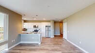 This well-appointed 2-bedroom, 2-bathroom residence in Birmingham, AL offers a thoughtfully designed single-floor layout with a seamless blend of modern finishes and functional living spaces. The open-concept kitchen and living area serves as the heart of the home, featuring white shaker cabinetry, granite countertops, a subway tile backsplash, stainless steel appliances, and pendant lighting over a central island. Hardwood-style flooring runs throughout the main living areas, complementing the neutral warm-gray color palette. Large windows in the living room flood the space with natural light and frame striking views of the Birmingham skyline. Both bedrooms are carpeted and offer ceiling fans, with the primary bedroom accompanied by a generously sized walk-in closet with wire shelving. The bathrooms are finished with granite-topped white vanities, tall storage cabinetry, and wood-look tile flooring. Three closets total provide ample storage throughout. Additional conveniences include an in-unit laundry area and a dedicated utility room. The clean, contemporary aesthetic is carried consistently through every room, creating a cohesive and comfortable living environment.