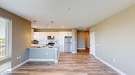 This well-appointed 2-bedroom, 2-bathroom residence in Birmingham, AL offers a thoughtfully designed single-floor layout with a seamless blend of modern finishes and functional living spaces. The open-concept kitchen and living area serves as the heart of the home, featuring white shaker cabinetry, granite countertops, a subway tile backsplash, stainless steel appliances, and pendant lighting over a central island. Hardwood-style flooring runs throughout the main living areas, complementing the neutral warm-gray color palette. Large windows in the living room flood the space with natural light and frame striking views of the Birmingham skyline. Both bedrooms are carpeted and offer ceiling fans, with the primary bedroom accompanied by a generously sized walk-in closet with wire shelving. The bathrooms are finished with granite-topped white vanities, tall storage cabinetry, and wood-look tile flooring. Three closets total provide ample storage throughout. Additional conveniences include an in-unit laundry area and a dedicated utility room. The clean, contemporary aesthetic is carried consistently through every room, creating a cohesive and comfortable living environment.