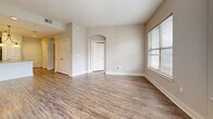 Located at 1925 Monroe Dr NE in Atlanta's vibrant Midtown area, this two-bedroom, two-bathroom residence offers a well-designed single-floor layout with a cohesive, modern aesthetic throughout. Wood-style plank flooring runs continuously across the living areas and bedrooms, complemented by neutral warm-gray walls and crisp white trim that create a clean, inviting ambiance.

The open kitchen and living area serves as the heart of the home. The kitchen is appointed with rich dark-espresso cabinetry, granite countertops, a tile backsplash, stainless steel appliances including a refrigerator and microwave, and a central island with an integrated sink and pendant lighting overhead — ideal for both everyday cooking and casual entertaining.

Both bedrooms are generously proportioned and filled with natural light from large windows with horizontal blinds. The primary bedroom features a corner window arrangement, maximizing daylight and views of the surrounding neighborhood. Each bedroom is served by its own dedicated closet.

The two bathrooms are finished with large-format neutral tile. The primary bath includes a glass-enclosed walk-in shower, while the secondary bath offers a tiled tub-shower combination with a dark-cabinetry vanity topped with granite. Together, these spaces provide a functional and polished retreat in the heart of Atlanta.