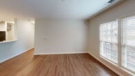 Located at 1901-1903 Florance St in Savannah, GA, this single-floor, 2-bedroom, 2-bathroom residence offers a functional and modern layout designed for comfortable living. Rich, dark wood-style flooring flows through the open-concept living and kitchen area, creating a cohesive and inviting atmosphere. The living room is bathed in natural light through large windows fitted with blinds, complemented by a ceiling fan for added comfort. The kitchen features sleek gray cabinetry, light quartz countertops with a peninsula, black appliances including a refrigerator, range, and over-the-range microwave, and a double-basin sink — combining style with practicality. The spacious primary bedroom includes a double-door closet and lighter wood-style flooring, offering generous storage. The second bedroom is equally well-sized with its own closet space. Both bathrooms are finished in a clean, neutral palette, each equipped with a tub-shower combination, a gray vanity with a white countertop, a large mirror, and wood-style flooring. A dedicated closet provides additional storage. The overall aesthetic is modern and move-in ready, with neutral tones and consistent finishes throughout.