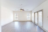 Located in Atlanta's vibrant Grant Park neighborhood, this well-appointed 2-bedroom, 2-bathroom home offers a thoughtfully designed single-level layout. The open-concept living room is bright and airy, featuring light hardwood-style flooring, a ceiling fan, multiple windows with blinds, and sliding glass door access that floods the space with natural light. A long hallway connects the main living areas to the private bedrooms, providing a clear separation of spaces.

The kitchen is a standout feature, boasting rich dark wood cabinetry, granite countertops with an extended breakfast bar, stainless steel appliances including a refrigerator, range, and microwave, and track lighting overhead — ideal for both cooking and entertaining.

The generously sized primary bedroom features hardwood-style flooring, a ceiling fan, and direct access to its own bathroom. The second bedroom offers plush carpeting and multiple windows with garden views, creating a comfortable, light-filled retreat. Both bedrooms are served by dedicated closets with wire shelving systems, offering practical storage solutions.

The primary bathroom is well-equipped with a separate glass-enclosed shower, a soaking tub with tile surround, and tile flooring. A dedicated in-unit laundry room with a full-size washer and dryer adds everyday convenience to this well-rounded home.