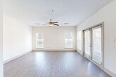 Located in Atlanta's vibrant Grant Park neighborhood, this well-appointed 2-bedroom, 2-bathroom home offers a thoughtfully designed single-level layout. The open-concept living room is bright and airy, featuring light hardwood-style flooring, a ceiling fan, multiple windows with blinds, and sliding glass door access that floods the space with natural light. A long hallway connects the main living areas to the private bedrooms, providing a clear separation of spaces.

The kitchen is a standout feature, boasting rich dark wood cabinetry, granite countertops with an extended breakfast bar, stainless steel appliances including a refrigerator, range, and microwave, and track lighting overhead — ideal for both cooking and entertaining.

The generously sized primary bedroom features hardwood-style flooring, a ceiling fan, and direct access to its own bathroom. The second bedroom offers plush carpeting and multiple windows with garden views, creating a comfortable, light-filled retreat. Both bedrooms are served by dedicated closets with wire shelving systems, offering practical storage solutions.

The primary bathroom is well-equipped with a separate glass-enclosed shower, a soaking tub with tile surround, and tile flooring. A dedicated in-unit laundry room with a full-size washer and dryer adds everyday convenience to this well-rounded home.
