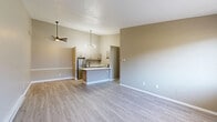 Located at 988 Muirwood Village Dr. in Columbus, OH, this 2-bedroom, 1-bathroom unit offers a thoughtfully designed single-level layout with a clean, modern aesthetic throughout. Light-toned luxury vinyl plank flooring runs seamlessly across the entire space, complementing the neutral taupe and greige wall tones that create a warm, cohesive atmosphere.

The open kitchen is a standout feature, boasting vaulted ceilings, a striking sputnik-style chandelier, a marble-look countertop peninsula, stainless steel appliances including a refrigerator and gas range, and taupe cabinetry with contemporary hardware. The adjacent living room is bright and welcoming, with a large window that draws in natural light, a wall-mounted HVAC unit, and baseboard heating.

The primary bedroom is generously sized, featuring a ceiling fan, a window with an exterior view, and baseboard heating. The second bedroom maintains the same clean aesthetic with ample space and easy access. A well-organized walk-in closet with floor-to-ceiling wire shelving and hanging rods provides excellent storage. The full bathroom is finished with a white soaking tub and shower combination, black fixtures, and a crisp, clean design. A connecting hallway ties all rooms together in a practical and efficient floor plan.