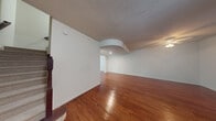 Located at 6116 Yellow Sun Drive in Lantana, FL, this two-story home offers a thoughtfully designed layout spread across two well-proportioned floors. Rich hardwood flooring flows throughout the main living areas, adding warmth and continuity to the space.

The ground floor features an open-concept living and dining area bathed in natural light, with a ceiling fan overhead and sliding glass doors that open to an outdoor balcony with lush greenery views. The kitchen is equipped with rich wood cabinetry, granite countertops, stainless steel appliances including a refrigerator, range, and microwave, and recessed lighting. A pass-through counter connects the kitchen to the dining area, enhancing the open feel.

Upstairs, three bedrooms provide comfortable retreats. The generously sized primary bedroom features hardwood floors, a ceiling fan, and French doors leading to a private balcony with outdoor views. A large walk-in closet with wire shelving offers ample storage. The three bathrooms are finished with tile flooring, warm wood vanities, and tiled shower surrounds.

Two staircases connect the floors, and dedicated hallways maintain clear circulation throughout. The textured ceilings on the lower level add a classic touch, while the upper level maintains a clean, bright aesthetic throughout.