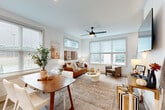Located at 277 Clifton St SE in Atlanta's vibrant Clifton Heights community, this contemporary three-story home offers four bedrooms and three bathrooms spread across three thoughtfully designed floors. Light-toned hardwood flooring flows throughout, complementing the clean white walls and modern aesthetic.

The main living level features an open-concept living and dining area bathed in natural light from multiple large windows dressed with horizontal blinds. A ceiling fan, stylish staircase with sleek metal railings, and seamless flow between spaces define this floor. The kitchen stands out with two-tone cabinetry — dark lower cabinets contrasting crisp white uppers — paired with white quartz countertops, stainless steel appliances, a central island with seating, and generous window views of the surroundings.

The bedrooms are bright and well-proportioned, each featuring ceiling fans and large windows that invite natural light. The primary bedroom offers a comfortable, serene retreat. The three bathrooms are finished in a consistent modern style, with dark wood vanities, white countertops, and matte black fixtures — one featuring a soaking tub and another a sleek glass-enclosed walk-in shower. Two staircases connect the floors efficiently, making this home as functional as it is stylish.