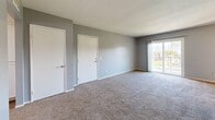 Located at 2265 Cahuilla St in Colton, California, this one-bedroom, one-bathroom unit offers a well-organized, single-floor layout designed for comfortable everyday living. The interior is finished in a consistent neutral gray palette with crisp white trim, creating a clean and cohesive aesthetic throughout.

The living room is carpeted and spacious, with sliding glass doors that open onto a private balcony, allowing natural light to fill the room and providing outdoor views. A dedicated dining area connects seamlessly to the kitchen, which features a galley-style layout with light wood-look flooring, white cabinetry, granite-look countertops, a stainless steel sink, and a black electric range with a range hood — offering ample counter and storage space.

The bedroom is generously sized and carpeted, with a large window dressed in vertical blinds that brings in natural light, and a double-door closet providing substantial storage. Additional closet spaces are found throughout the unit, totaling three, ensuring excellent organizational capacity.

The bathroom is neatly appointed with a full tub-shower combination, light wood-look flooring, a granite-look vanity countertop, and a window above the tub for natural ventilation. A hallway connects the main living areas, completing this practical and well-maintained floor plan.