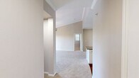 Located in Austin, TX, this single-floor, 2-bedroom, 2-bathroom home offers a well-organized layout designed for comfortable everyday living. The kitchen is a functional centerpiece, featuring white cabinetry with open shelving, granite-look countertops, a peninsula with a double sink, and wood-look flooring that extends into the adjacent living area. Crown molding adds a polished touch to the kitchen and living space. Both bedrooms are generously sized, finished with plush wall-to-wall carpeting and ceiling fans, and filled with natural light through slatted window blinds. The spacious primary bedroom benefits from two windows and ample room for furnishings, while the second bedroom includes convenient closet access. Two full bathrooms each include a tiled tub-shower combination with chrome fixtures and stone-look countertop vanities. Wood-look flooring carries through the bathrooms, hallway, and laundry room, providing a cohesive flow throughout. A dedicated laundry room with in-unit washer hookups adds everyday convenience. Two closets provide generous storage, and the entrance and hallway connect all spaces efficiently. Neutral tones throughout create a clean, move-in-ready aesthetic.