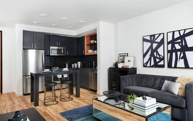 Shared Living Space Featuring Lounge, Kitchen Island, and Dining Zone - Pike Motorworks