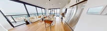 This contemporary apartment, situated at 100 Fullarton Street in London, Ontario, offers a harmonious blend of style and practicality within its 730 square feet. The space features two bedrooms, including a primary bedroom of 150 square feet, and two bathrooms, all thoughtfully designed for modern living.

The heart of the apartment is its open-concept living area, seamlessly integrating the kitchen and living room. Floor-to-ceiling windows dominate the space, flooding it with natural light and providing breathtaking panoramic views of the city skyline. The kitchen boasts sleek white cabinetry, stainless steel appliances, and a textured backsplash, complemented by a large island with seating for casual dining.

Both bedrooms offer ample space and storage, with the primary bedroom featuring expansive windows that frame the urban vista. The bathrooms are elegantly appointed, with one showcasing a glass-enclosed shower and modern fixtures.

Throughout the apartment, a neutral color palette enhances the sense of space, while warm wood flooring adds a touch of organic comfort. Strategic lighting, including recessed ceiling lights and pendant fixtures, creates a welcoming ambiance.

The apartment's layout maximizes functionality, with a hallway connecting the various spaces. Despite its compact footprint, the clever design ensures that each area feels distinct yet interconnected, perfect for both relaxation and entertaining.