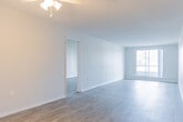 Located at 305 Margaret Ave in Kitchener, Ontario, this well-appointed 2-bedroom, 2-bathroom unit offers a comfortable and practical single-floor layout. Light-toned laminate flooring runs throughout the space, creating a cohesive and easy-to-maintain interior. The entrance leads into an open layout connecting the living area and kitchen, with neutral warm-grey walls and textured ceilings adding character throughout.

The kitchen is equipped with white cabinetry, stone-effect countertops, and stainless steel appliances including an electric range, providing a clean and functional cooking space. The spacious living room features a large sliding glass door that fills the area with natural light and offers views of the surrounding neighbourhood.

The generously sized primary bedroom includes a full-width sliding-door closet for ample storage, along with a window that brings in natural light. The second bedroom is also well-proportioned, featuring its own window with a neighbourhood view. An additional walk-in closet provides extra storage.

Both bathrooms are finished with tile flooring and white vanities with stone-effect countertops. One bathroom includes a full tub and shower combination, while the other features a standalone vanity with a medicine cabinet mirror. The overall ambiance is bright, clean, and move-in ready.