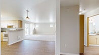Located at 1715 S Hayford Rd in Airway Heights, WA, this 3-bedroom unit offers a practical and comfortable single-floor layout. The open living room features a combination of hardwood-style flooring and plush carpet, a stylish pendant light, and a sliding glass door that leads to a private balcony with outdoor views, allowing natural light to fill the space. Two additional windows on the far wall further brighten the room.

The kitchen is well-appointed with light wood cabinetry, laminate countertops, and white appliances including a refrigerator, electric range, and dishwasher. A window above the sink provides natural light, and durable hardwood-style flooring ties the space together.

The generously sized primary bedroom offers ample room for furnishings, while the two additional bedrooms each feature carpet flooring and windows with blinds that bring in natural light. All bedrooms provide a neutral color palette conducive to a variety of décor styles.

The unit also includes a dedicated utility room for added convenience. Throughout, the warm, neutral tones and clean finishes create a bright and inviting atmosphere, making this a well-rounded and functional living space.