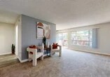 Located at 1175 W Blaine St in Riverside, California, this single-floor, 2-bedroom, 1-bathroom residence offers a practical and well-organized layout across a comfortable footprint. The unit features two distinct living areas, providing flexible space for both lounging and dining. The main living room is generously proportioned, finished with neutral carpet, and anchored by a textured ceiling. A standout feature is the large sliding glass door that opens to a balcony, flooding the room with natural light and offering views of surrounding greenery. An accent wall adds a touch of visual character to the space.

The galley-style kitchen is efficiently designed with white cabinetry, granite-style countertops, wood-look flooring, and white appliances including a gas range and refrigerator. A hallway connects the kitchen to the bathroom, which features a white vanity with dark countertop, a mirror, and a separate tub and toilet area with wood-look flooring.

Both bedrooms are carpeted and receive natural light through sliding windows with outdoor views. The primary bedroom offers a comfortable amount of space, while the second bedroom is well-suited as a guest room or office. The overall ambiance is clean, functional, and move-in ready.
