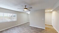 Located in Augusta, GA, this well-appointed 2-bedroom, 1-bathroom home offers a clean, modern aesthetic across its single-level floor plan. Wood-look flooring runs throughout the entire space, creating a cohesive and easy-to-maintain foundation in every room.

The kitchen is a standout feature, designed in a galley style with white shaker cabinets, light granite countertops, classic white subway tile backsplash, and stainless steel appliances including a refrigerator and electric range. Ample cabinet storage and counter space make it both functional and visually appealing.

The living area is bright and open, featuring a textured ceiling, ceiling fan with light fixture, and a window that brings in natural light. Neutral warm-gray walls complement the flooring and create a welcoming atmosphere throughout.

Both bedrooms are comfortably sized, each equipped with a ceiling fan, and benefit from natural light through windows with blinds. The primary bedroom includes closet access via a classic six-panel door. The bathroom features a white vanity with granite countertop and brushed nickel fixtures, maintaining the consistent modern finish seen across the home.

A hallway connects the bedrooms and bathroom, reinforcing the efficient and practical layout of this Augusta residence.