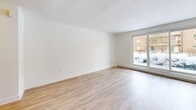 This contemporary apartment offers 780 square feet of thoughtfully designed living space. The open-concept layout maximizes the use of space, creating a seamless flow between rooms. The living area is spacious and flooded with natural light from large windows, providing a bright and airy ambiance.

The kitchen is a highlight, featuring modern white cabinetry, sleek countertops, and stainless steel appliances. Subway tile backsplash adds a touch of classic elegance. The cooking space is efficiently designed with ample storage and prep areas.

Two bedrooms offer comfortable sleeping quarters, with the primary bedroom measuring 140 square feet. Both rooms feature large windows and neutral decor, allowing for personalization. The bathroom is pristine, with a white subway-tiled shower/tub combination and modern fixtures.

Throughout the apartment, light-toned hardwood-style flooring adds warmth and continuity. Clean white walls and baseboards contribute to the fresh, modern aesthetic. The property's single floor layout enhances accessibility and ease of movement.

Located at 640 Fanshawe Park Rd E in London, Ontario, this apartment combines contemporary style with practical living, ideal for those seeking a modern urban lifestyle.