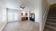 Located at 1001 Pinehurst Drive in Spring Hill, TN, this two-story home offers 2 bedrooms and 2 bathrooms across two well-proportioned floors. The main level provides generous living space, highlighted by wood-look flooring that flows throughout the open-concept kitchen and living area. The kitchen is well-appointed with warm-toned cabinetry, granite countertops, a stainless steel sink, a tile backsplash, and a full suite of black appliances including a refrigerator, range, microwave, and dishwasher. The living room benefits from natural light through blinds-fitted windows and is finished with a ceiling fan and textured ceiling. The upper level hosts the bedrooms, each featuring plush carpet flooring, ceiling fans, and multiple windows that invite natural light. The spacious primary bedroom includes windows on two walls, creating a bright and airy retreat. Both bathrooms are consistently finished with rich wood vanities, granite countertops, framed mirrors, and tub-shower combinations — one with a soaking tub and one with a shower unit. A staircase connects the two levels, complemented by a hallway that provides smooth circulation. Neutral tones and consistent finishes throughout lend the home a cohesive, move-in-ready appeal.