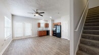 Located at 1001 Pinehurst Drive in Spring Hill, TN, this two-story home offers 2 bedrooms and 2 bathrooms across two well-proportioned floors. The main level provides generous living space, highlighted by wood-look flooring that flows throughout the open-concept kitchen and living area. The kitchen is well-appointed with warm-toned cabinetry, granite countertops, a stainless steel sink, a tile backsplash, and a full suite of black appliances including a refrigerator, range, microwave, and dishwasher. The living room benefits from natural light through blinds-fitted windows and is finished with a ceiling fan and textured ceiling. The upper level hosts the bedrooms, each featuring plush carpet flooring, ceiling fans, and multiple windows that invite natural light. The spacious primary bedroom includes windows on two walls, creating a bright and airy retreat. Both bathrooms are consistently finished with rich wood vanities, granite countertops, framed mirrors, and tub-shower combinations — one with a soaking tub and one with a shower unit. A staircase connects the two levels, complemented by a hallway that provides smooth circulation. Neutral tones and consistent finishes throughout lend the home a cohesive, move-in-ready appeal.