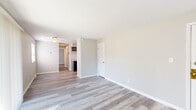 Located at 7852 Marten Ct S in Lawrence, Indiana, this efficiently designed one-bedroom, one-bathroom unit offers a thoughtful layout across a single floor. Light-toned luxury vinyl plank flooring runs throughout the entire space, providing a clean, cohesive look that ties each room together seamlessly.

The open living area benefits from generous natural light, thanks to a large sliding glass door fitted with vertical blinds that lead to the exterior. The neutral warm-gray walls create a bright, inviting atmosphere throughout.

The kitchen is well-appointed with dark espresso cabinetry offering ample upper and lower storage, granite-style countertops, a stainless steel sink, and black appliances including a range and refrigerator — delivering a functional and stylish cooking space.

The bedroom is a comfortably sized retreat featuring neutral tones, its own closet, and easy access to the rest of the unit via a hallway corridor. The space is complemented by three total closets, offering generous storage throughout the home.

The bathroom is neatly finished with wood-look tile flooring, a tub, and a marble-tiled walk-in shower with brushed gold hardware accents, adding a touch of elegance. A dedicated utility room and additional closets round out this practical and move-in-ready home.