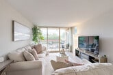 Located at 1300 Sanderson Dr in Sterling, Virginia, this well-appointed one-bedroom, one-bathroom residence offers a thoughtfully designed single-floor layout with a warm, contemporary aesthetic throughout. Light wood-look flooring flows seamlessly across the living areas, creating a cohesive and inviting atmosphere.

The main living room features neutral walls, ample seating space, and is anchored by a welcoming entryway complete with a console table and round mirror. A second living area serves as a flexible space, easily functioning as a home office or den. The galley-style kitchen is a standout feature, showcasing gray shaker cabinetry with matte black hardware, white quartz countertops, a stainless steel sink, and black appliances. The bright dining area benefits from multiple windows that bring in generous natural light and offer outdoor views.

The bedroom is a comfortable retreat with a dedicated closet, a window dressed with sheer curtains, and light wood flooring that continues from the main living spaces. The bathroom is finished with a gray shaker vanity, a white quartz countertop, matte black fixtures, and a large frameless mirror. A hallway and closet complete the functional layout of this efficiently designed Sterling residence.