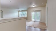 Located at 420 Salt Meadow Cir in Bradenton, Florida, this single-story, 3-bedroom, 2-bathroom home offers a well-designed layout with a seamless flow throughout. The open-concept living, dining, and kitchen area serves as the heart of the home, filled with natural light from large windows and a sliding glass door that opens to an outdoor balcony. The living area features wood-look flooring, a ceiling fan, and plush carpeting that defines the living space.

The kitchen is a standout, boasting rich dark cabinetry, a mosaic tile backsplash, granite countertops, a center island with pendant lighting, and black appliances including a refrigerator, dishwasher, range, and microwave.

The three bedrooms are comfortably sized, carpeted, and each benefit from natural light through slatted windows with views of surrounding greenery. The primary bedroom is generously proportioned and accompanied by ample closet space. In total, five closets provide exceptional storage throughout the home.

The two bathrooms are well-appointed — one features a walk-in glass shower with white tile surround and a dark wood vanity with granite countertop, while the second includes a full tub and shower combo with white tile. Additional conveniences include a dedicated laundry area and a connecting hallway that ties all rooms together efficiently.