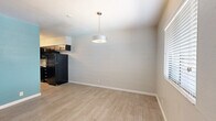 Located at 2302 E Fort Lowell Rd in Tucson, AZ, this single-story 1-bedroom, 1-bathroom unit offers a well-organized and functional layout. Throughout the space, wood-look tile flooring provides a warm, cohesive aesthetic, while painted concrete block walls lend a distinct character to each room.

The living room is an open, inviting area highlighted by a ceiling fan, a bold teal entry door, a window with blinds that brings in natural light, and a pendant light fixture that adds a modern touch. A vibrant teal accent wall frames the passage into the kitchen, creating a lively focal point.

The kitchen is efficiently designed with dark espresso cabinetry, granite-style countertops, a stainless steel sink, and a full suite of black appliances including a refrigerator and dishwasher, offering both style and practicality.

The bedroom is a comfortable, well-sized retreat featuring a ceiling fan, a sliding closet, and the same exposed concrete block wall design seen throughout. A stacked washer and dryer unit is conveniently tucked into the bedroom area, adding in-unit laundry without sacrificing space.

The bathroom is clean and straightforward, complete with a tub/shower combination, a vanity with dark cabinetry, and wood-look tile flooring that ties the space together seamlessly.