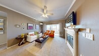 Located at 8000 Spring Mountain Rd in Las Vegas, NV, this well-designed 2-bedroom, 2-bathroom residence offers a comfortable and functional single-floor layout. The open-concept living, dining, and kitchen area forms the heart of the home. The carpeted living room is bright and welcoming, featuring crown molding, a ceiling fan, a white-mantled fireplace, and a sliding glass door that leads to a private patio with outdoor views. The adjacent dining area is defined by an elegant chandelier and crown molding, creating an intimate setting for meals. The kitchen is equipped with light wood cabinetry, ample counter space, and full appliances including a dishwasher, range, microwave, and refrigerator, all complemented by wood-style flooring. The primary bedroom is generously sized, carpeted, and filled with natural light from a large window, accompanied by a ceiling fan. Three closets, including a walk-in, provide excellent storage throughout. The bathrooms feature white cabinetry with stone-look countertops, white tile tub-shower combinations, and wood-style flooring. A dedicated in-unit laundry area adds everyday convenience, rounding out this practical and inviting Las Vegas residence.